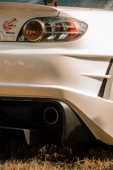 Detailed shot of a Mazda RX-8 taillight with Monza sticker, showcasing automotive design.