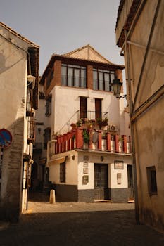 Discover a quaint alley with rustic buildings in a historic urban town setting during daylight.