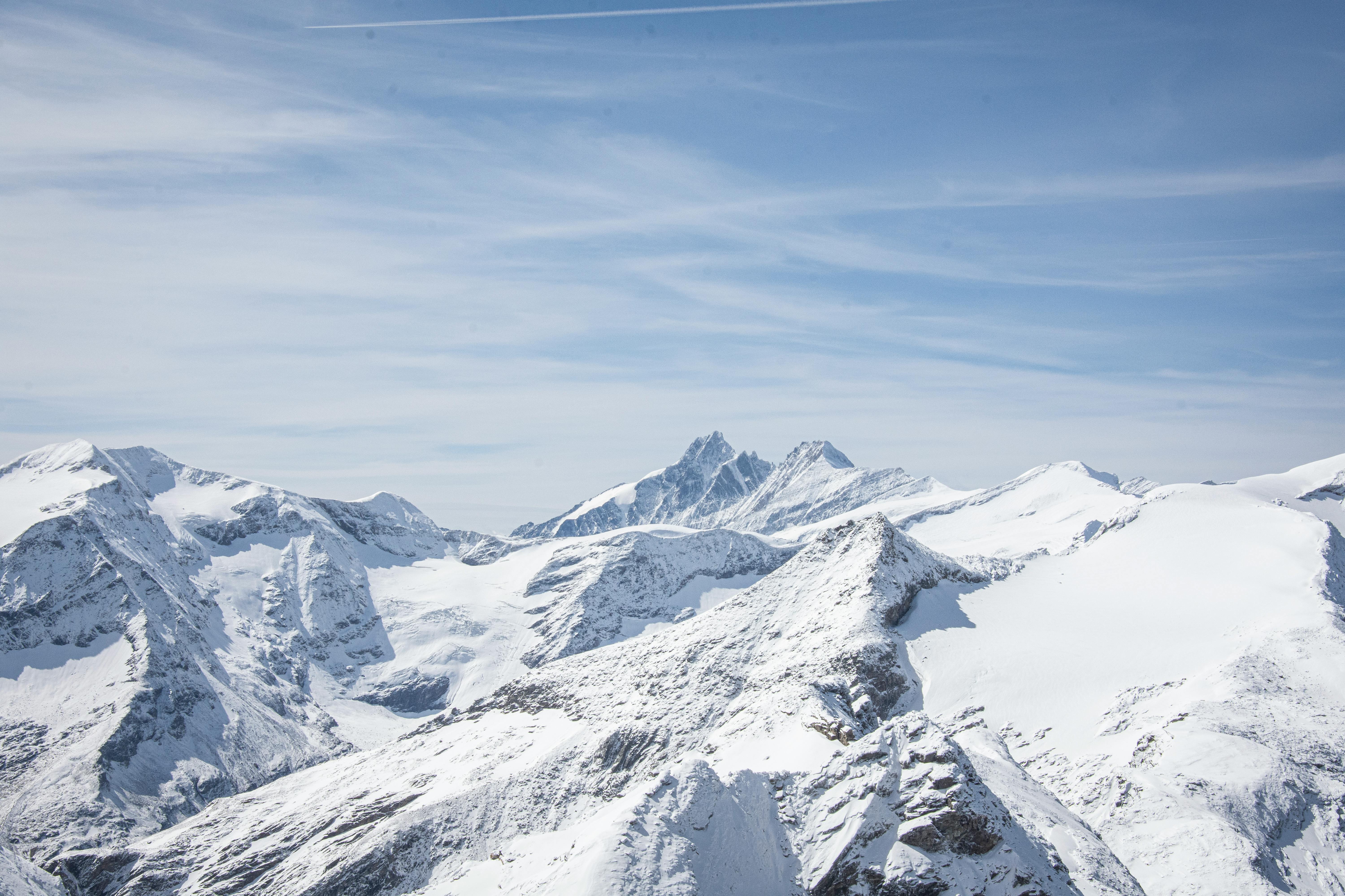 Prescription Goggle Inserts - A breathtaking view of snow-capped mountain peaks under a clear blue sky.