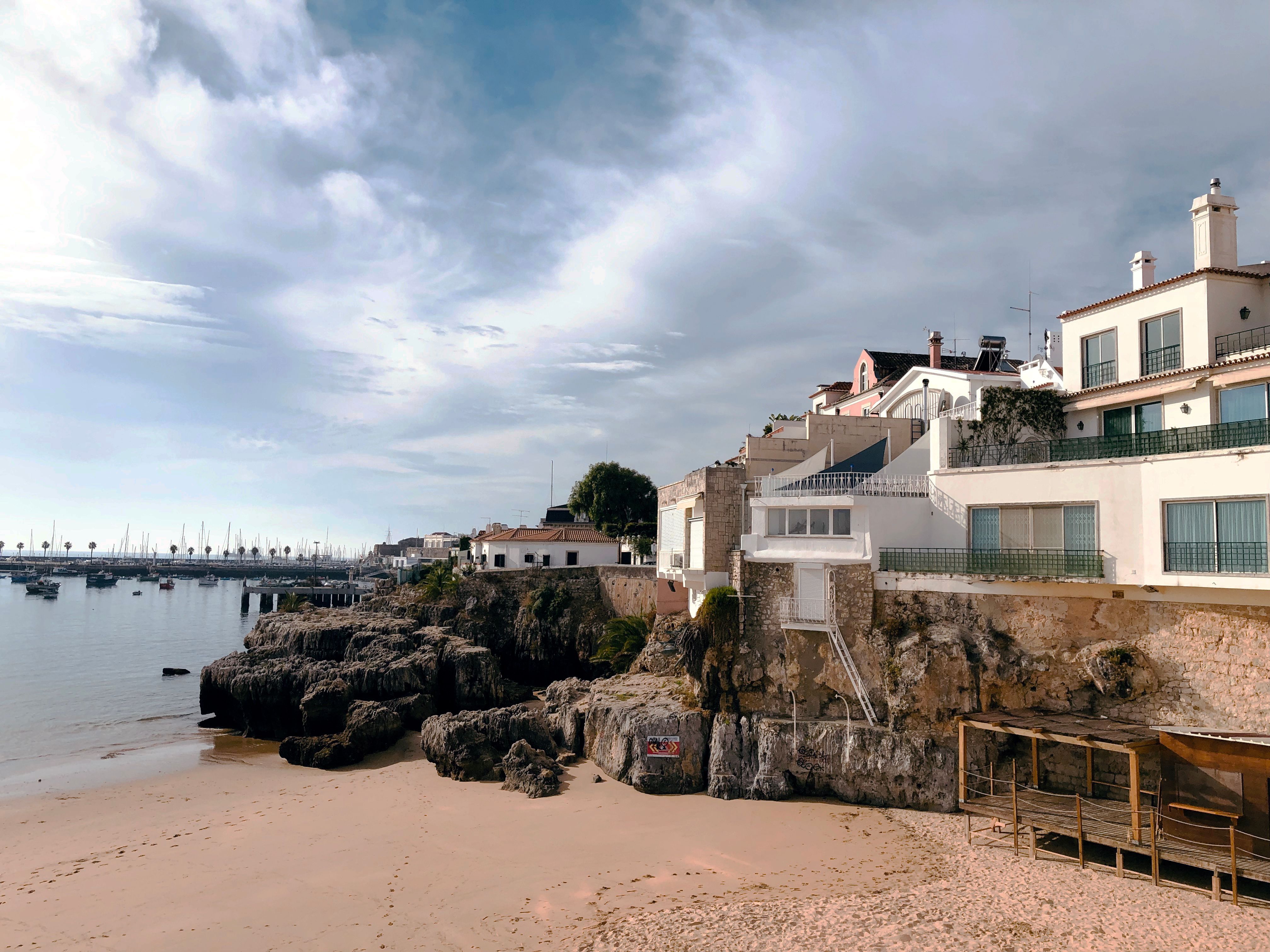 Fishing boats and a small sandy bay in the town of Cascais