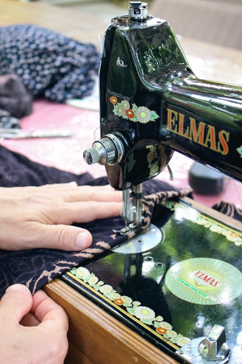 Hands Stitching Fabric Using Vintage Sewing Machine