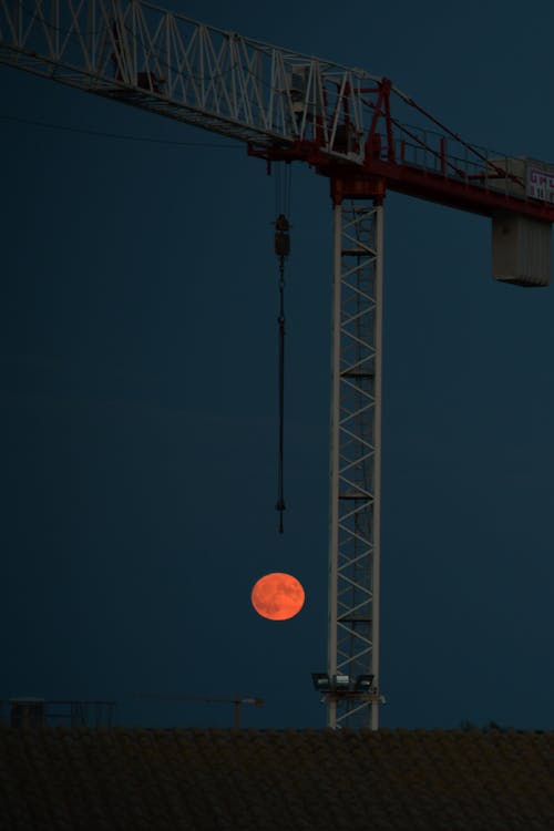Construction Crane over Eclipse of Moon