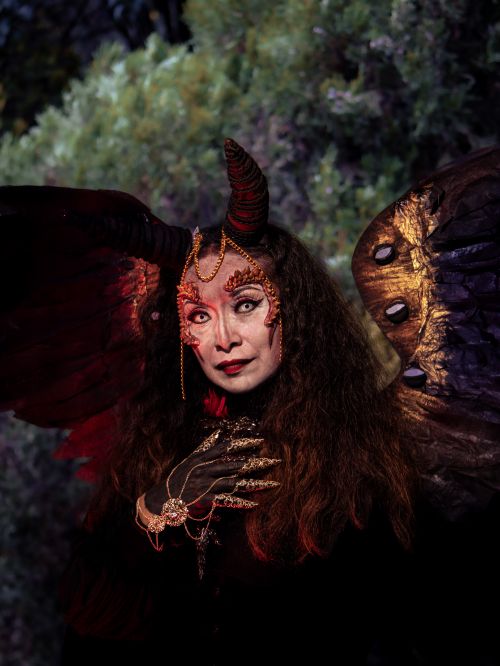 Free A mystical woman in fantasy costume with horns and wings, invoking a sense of mystery and enchantment. Stock Photo