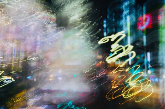 Vibrant abstract light trails in a cityscape, showcasing urban nightlife energy and movement.