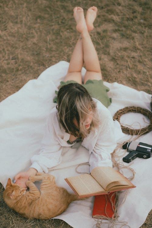 Woman with Cat and Book on Picnic