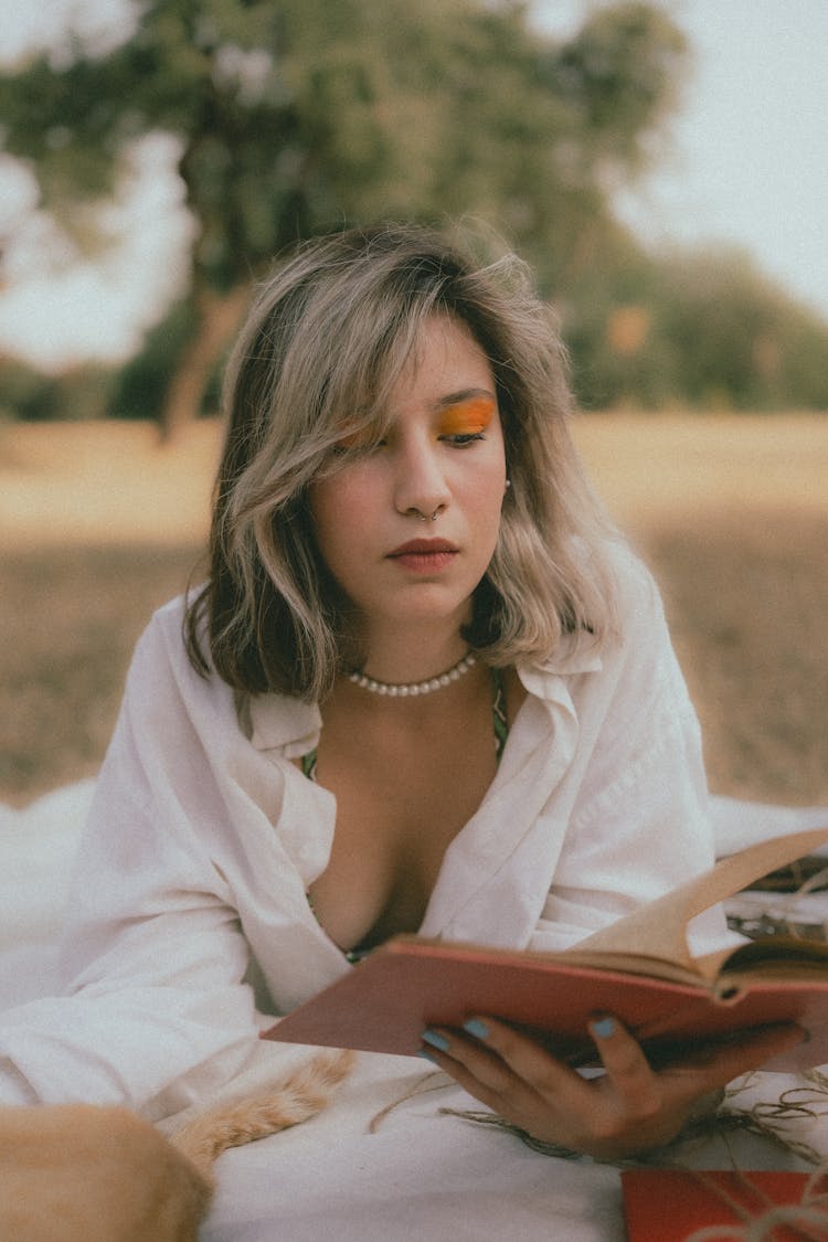 Woman Reading Book On Picnic