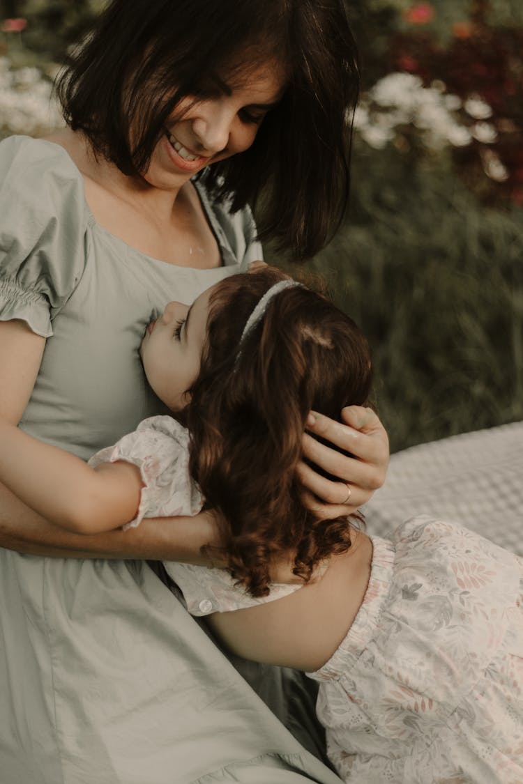 Smiling Mother Hugging Daughter