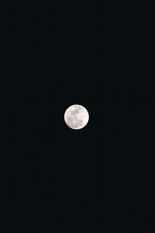 Free A clear and captivating photograph of the full moon set against a dark night sky, showcasing lunar details. Stock Photo