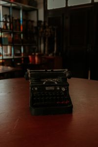 An old typewriter on a wooden table — photo by Dhemer Gonçalves on Pexels