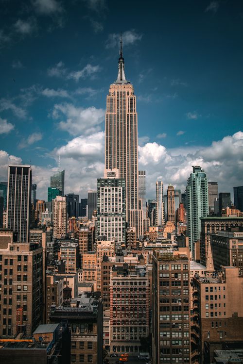Free Aerial view of the Empire State Building amid a vibrant New York City skyline. Stock Photo