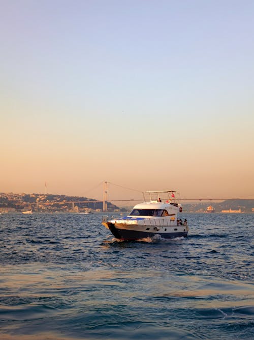 Motor Yachts Sailing on Bosphorus at Sunset
