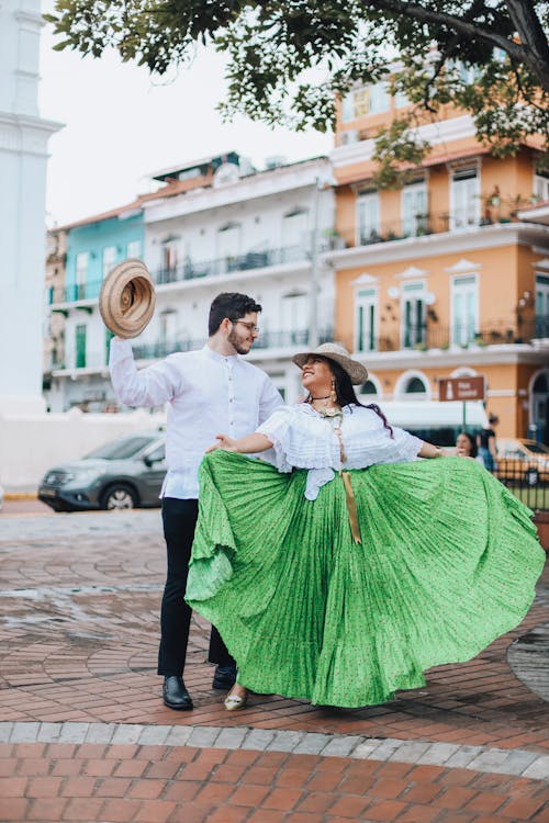 Man and Woman in Traditional Clothing Dancing on the Street 