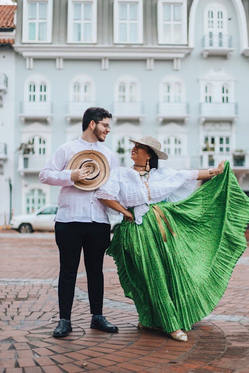 Man and Woman in Traditional Clothing Dancing on the Street 