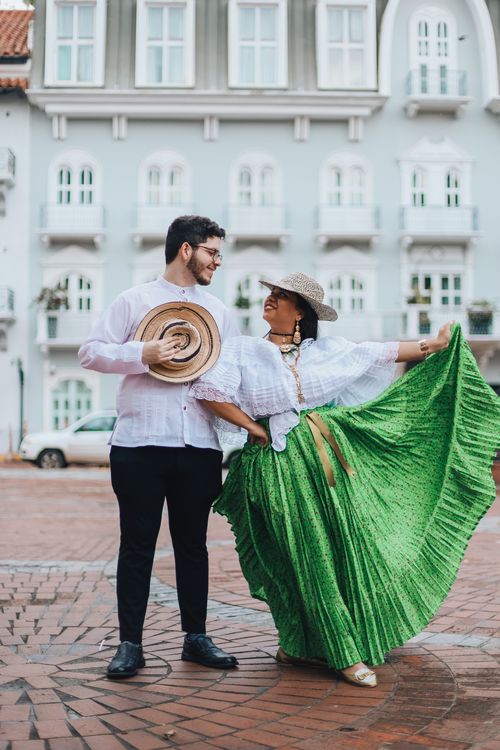 Free A couple dances in traditional Panamanian clothing in an urban street, capturing cultural essence. Stock Photo