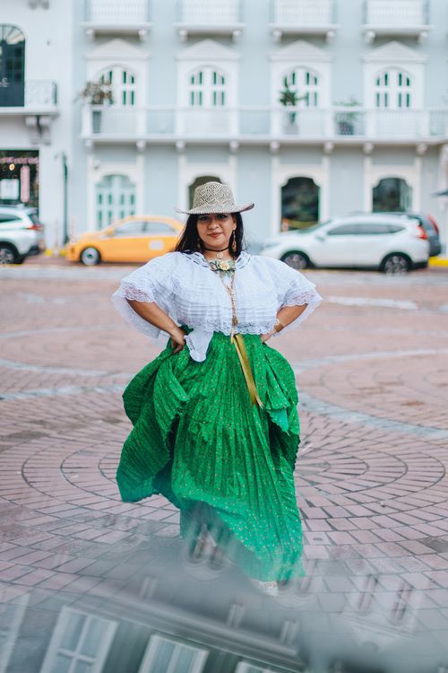 Free Woman in colorful traditional clothing posing in a city street. Stock Photo