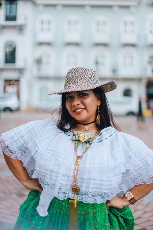 Free Young woman in Panama wearing traditional attire, smiling on city streets. Stock Photo