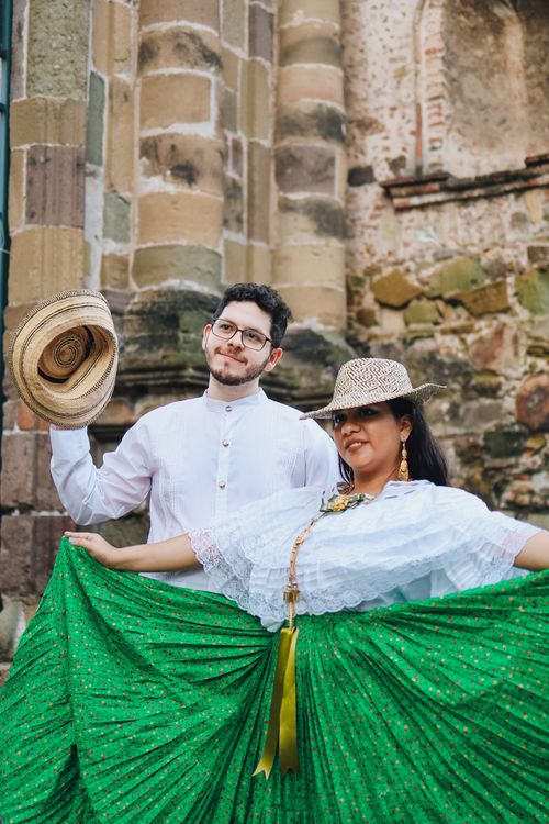 Free Couple in Panama posing in traditional attire near historical architecture. Stock Photo