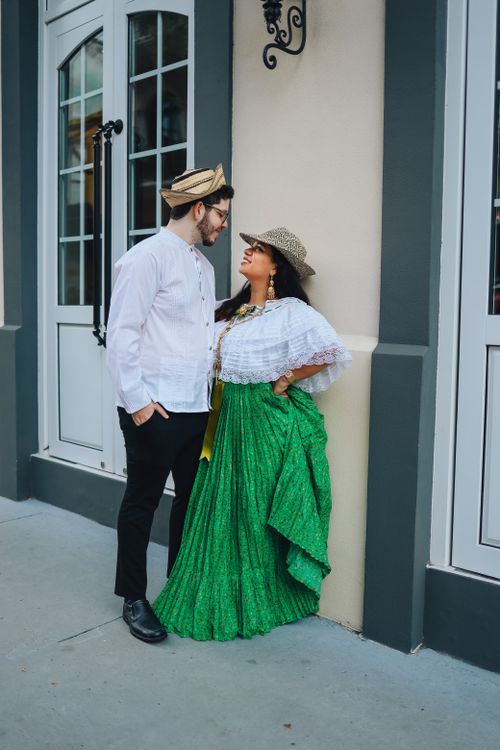 Free A couple poses in traditional Panamanian costumes on a city street, showcasing cultural fashion. Stock Photo