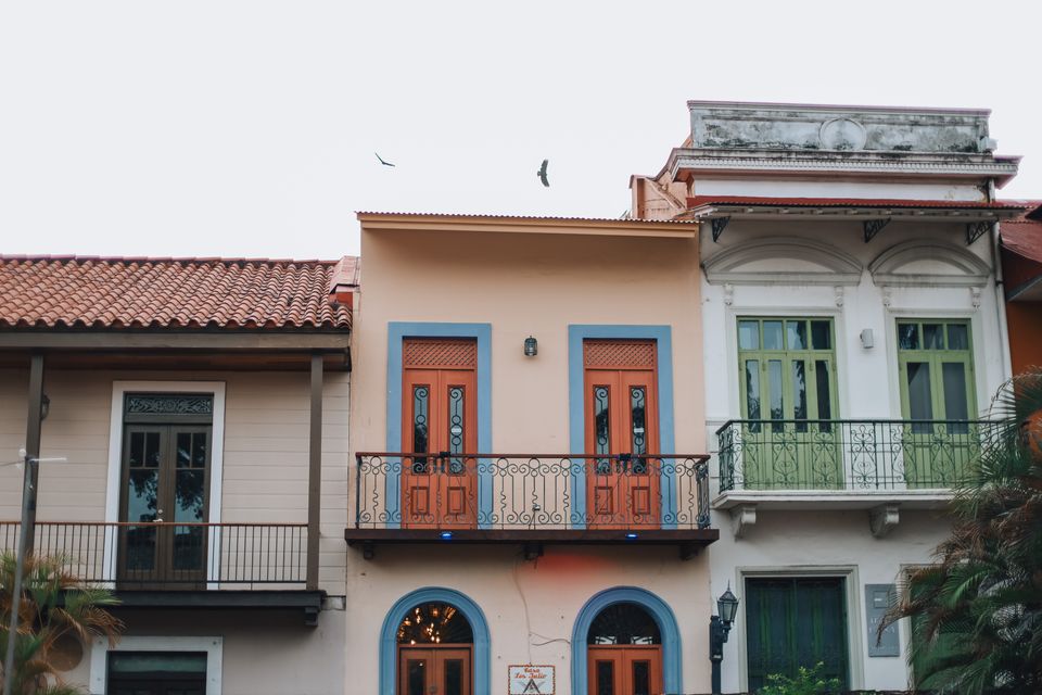 Pastel facades and ironwork balconies