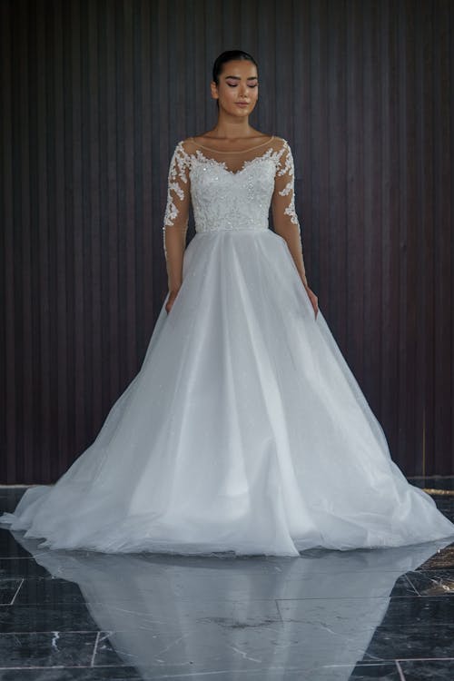 Young Woman in Bridal Dress Posing in Studio