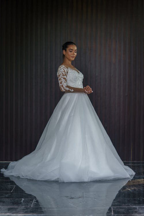 Young Woman in Bridal Dress Posing in Studio