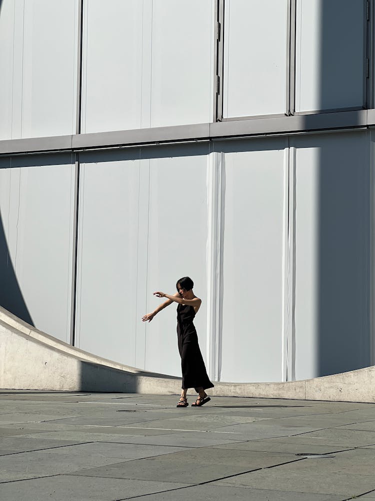 Woman Wearing Black Dress On A Square