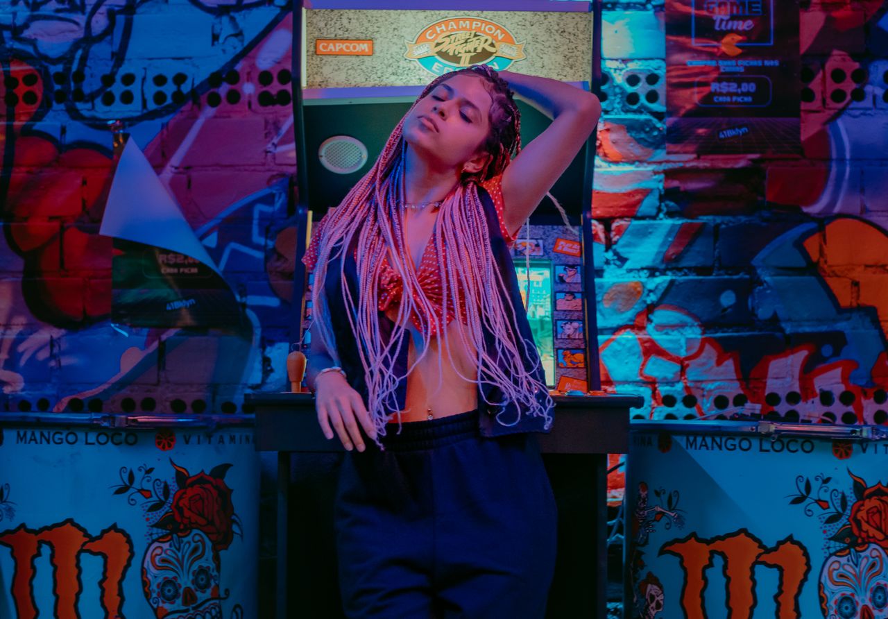 stylish woman in a nightclub setting with vibrant graffiti and arcade