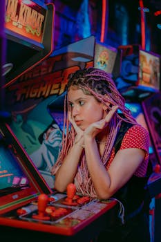 A young woman with braided hair plays arcade games, capturing the fun and colorful vibe.