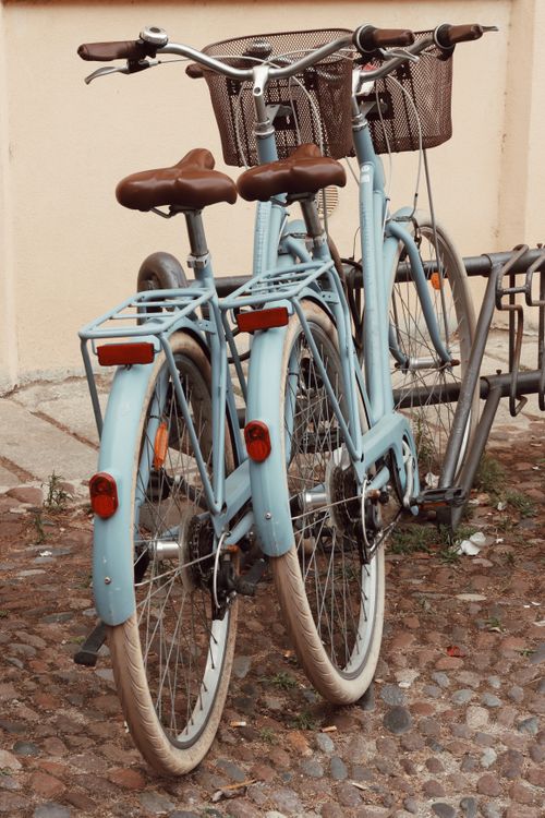 Free Charming vintage blue bikes parked outdoors in Alghero, Sardinia, Italy, offering a classic travel feel. Stock Photo