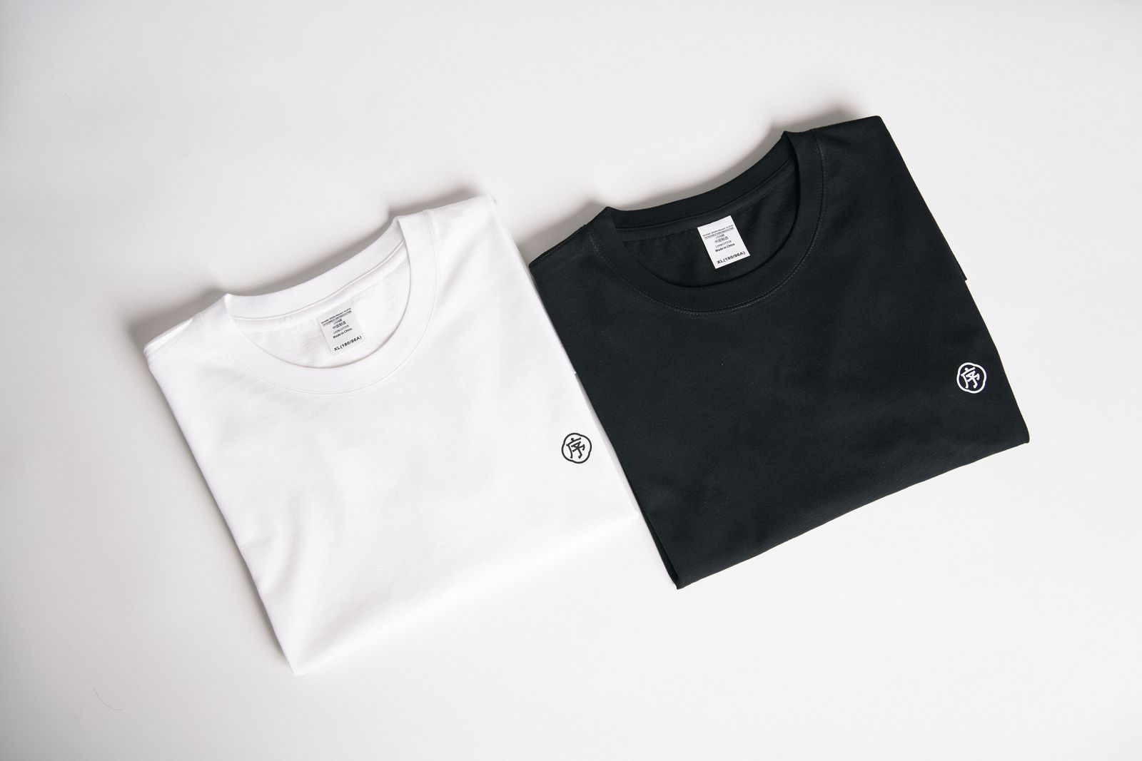 White and black cotton t-shirts folded flat