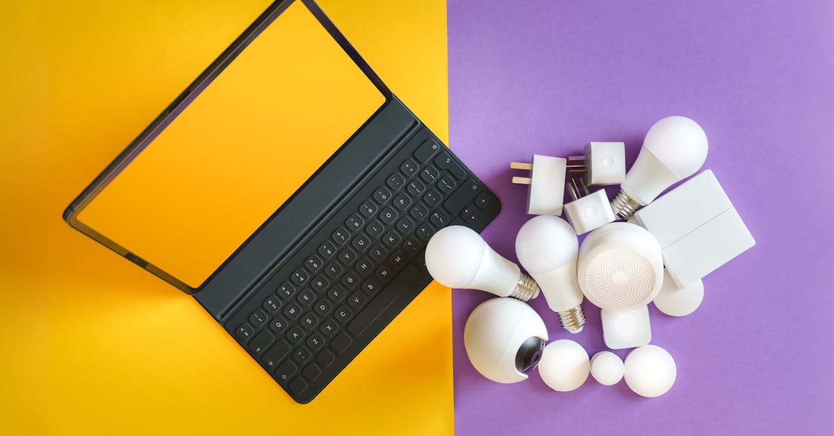 Flat lay of smart home gadgets and a keyboard on vibrant background depicting modern technology.