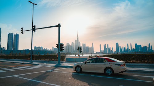 Taxi Standing in Front of a Crosswalk with the Dubai Skyline in the Background