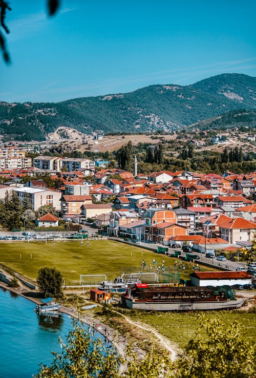 Houses on River Bank in Mountains Landscape