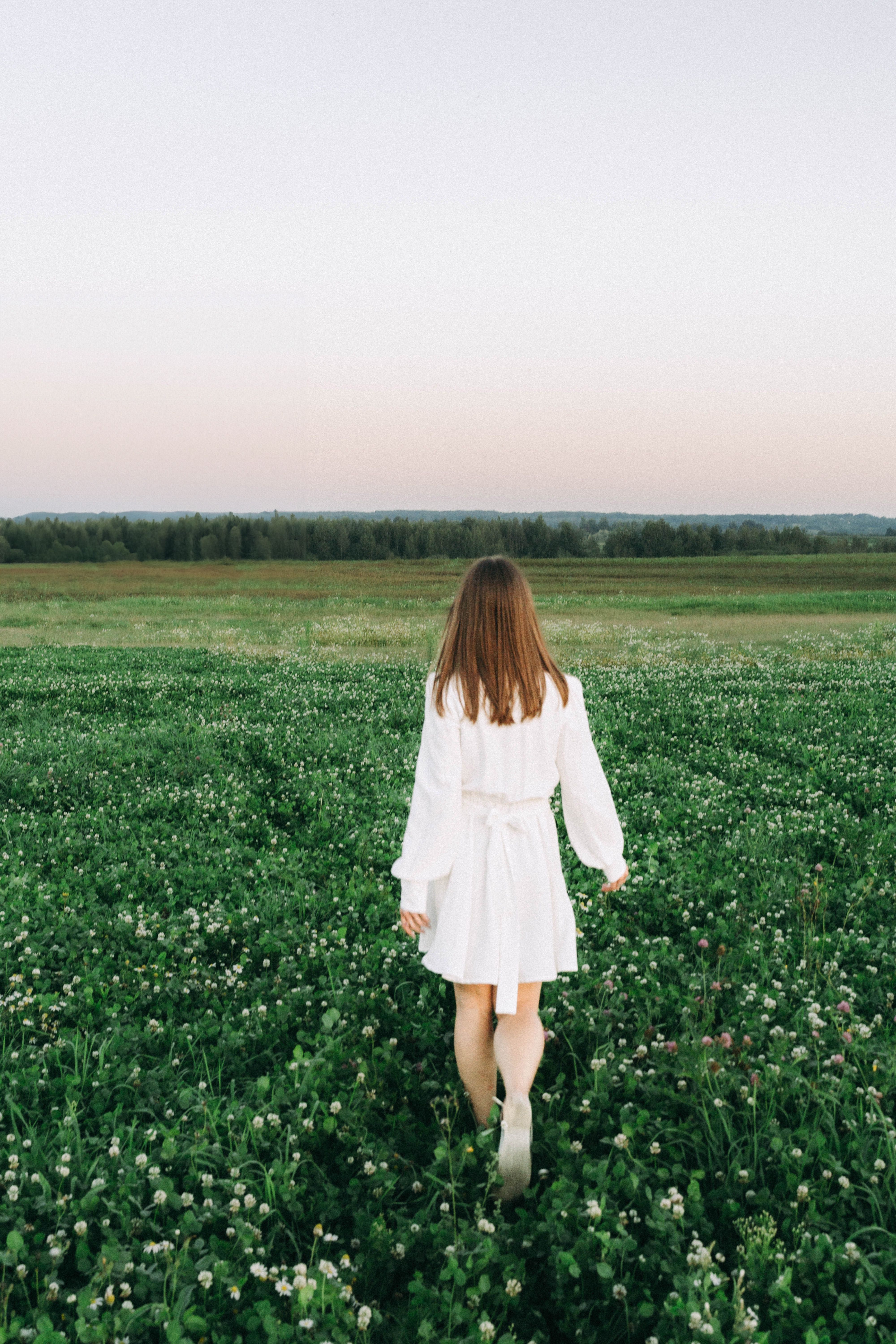 Woman in a White Mini Dress Walks in a Meadow · Free Stock Photo