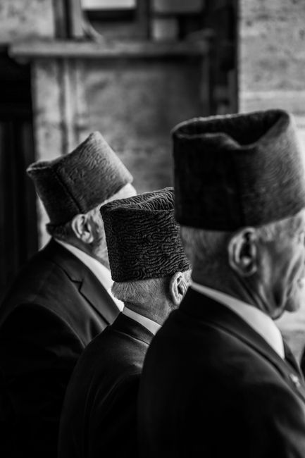 Black and white photo of elderly men in traditional hats in Ankara, Turkey.