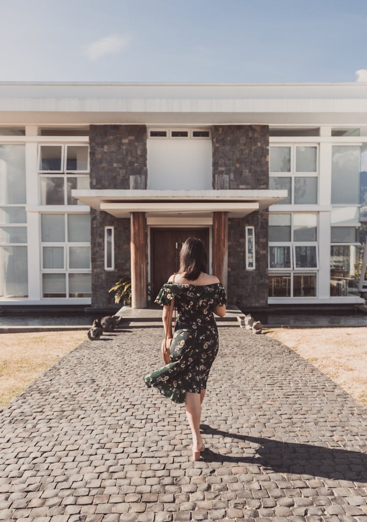 Woman In Dress Walking To House