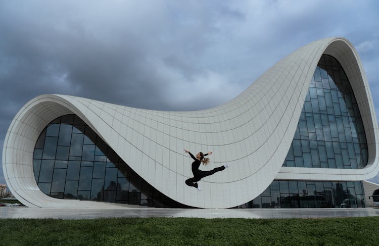 Woman Dancing Near Modern Building 