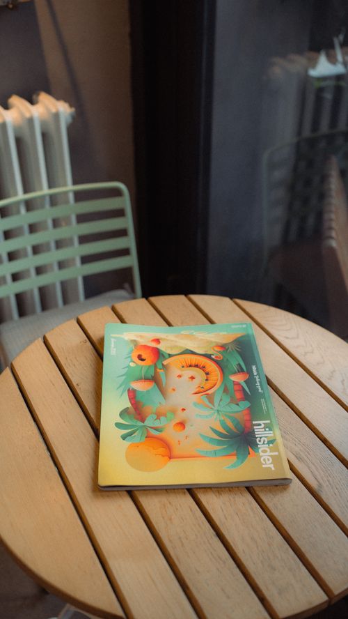 Free A stylish magazine on a wooden round table in a cozy İstanbul cafe setting. Stock Photo