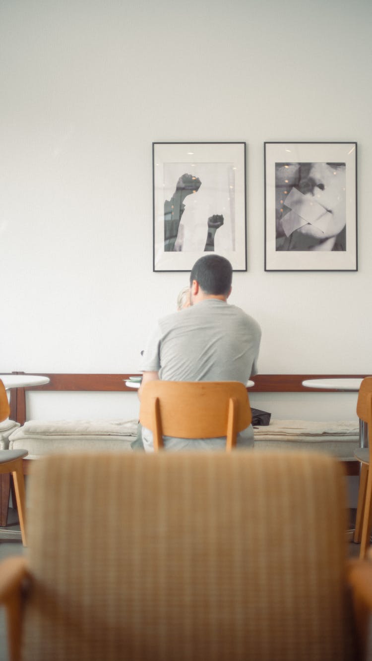 People Sitting At Table In Cafe