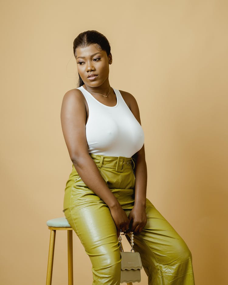 Woman In White Tank Top Sitting On Stool