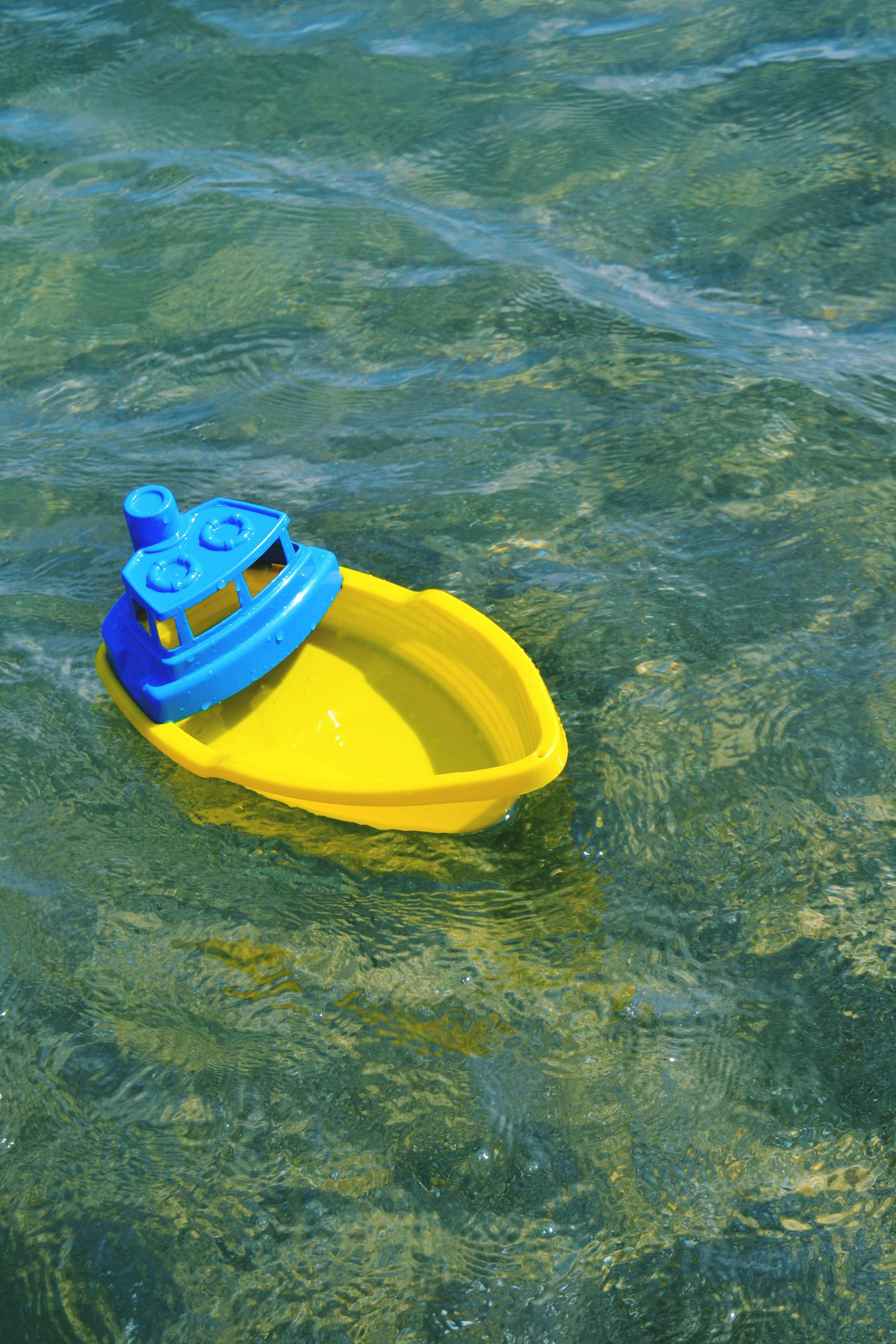 Plastic Colorful Boat Sailing on Water · Free Stock Photo