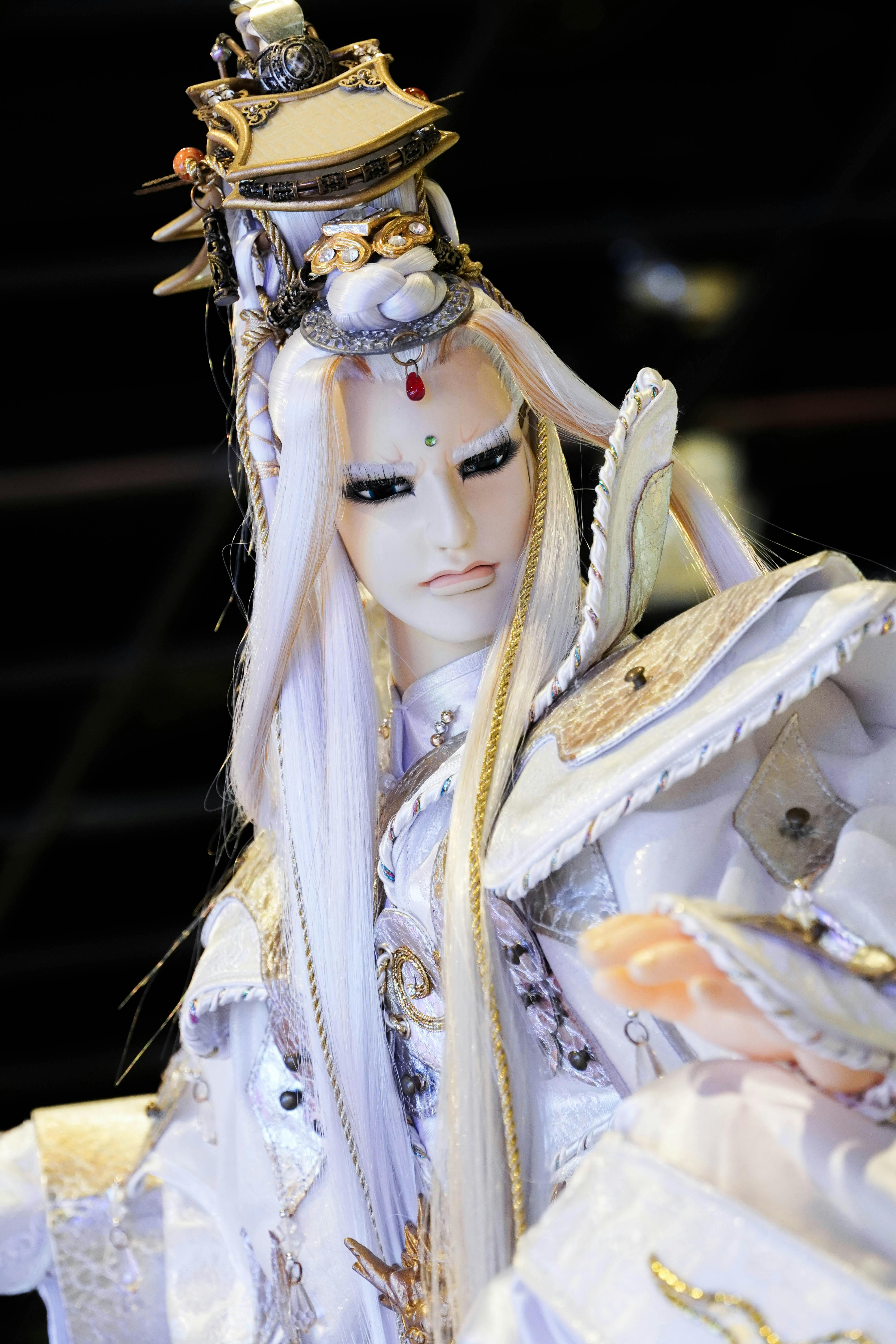 Elegant fantasy figurine dressed in ornate costume, showcasing fine craftsmanship.