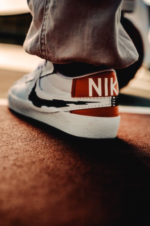 Free Fashion-forward sneaker in urban setting, captured from unique angle. Stock Photo