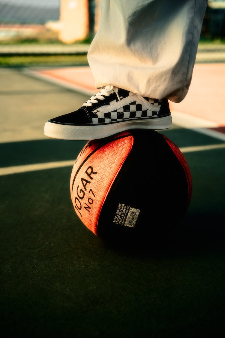 Feet In Vans Sneaker On Ball