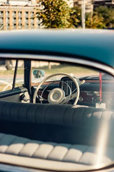 Interior view of a vintage car with a retro steering wheel in İstanbul's scenic backdrop.