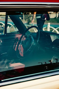 Close-up view of a vintage car's interior with a classic steering wheel in Istanbul, Türkiye.