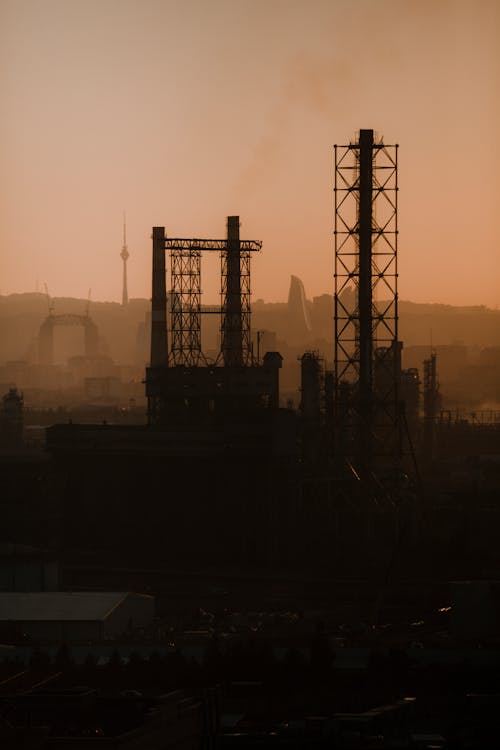 Factory in Town at Sunset