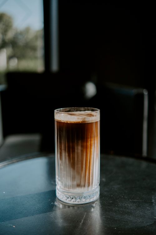 Free A refreshing iced coffee in a glass on a cafe table with natural light. Stock Photo