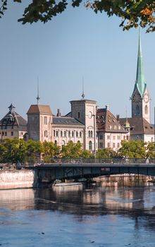 A tranquil scene capturing Zürich's historic architecture and picturesque river view.