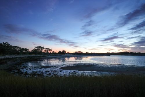 Free Beautiful twilight view of Stamford lakeshore with dramatic sky and calm waters. Stock Photo